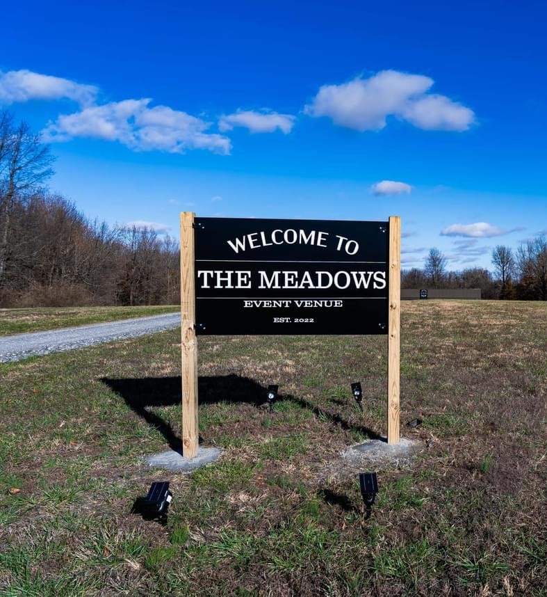 A picture of the welcom sign for The Meadows Event Venue.