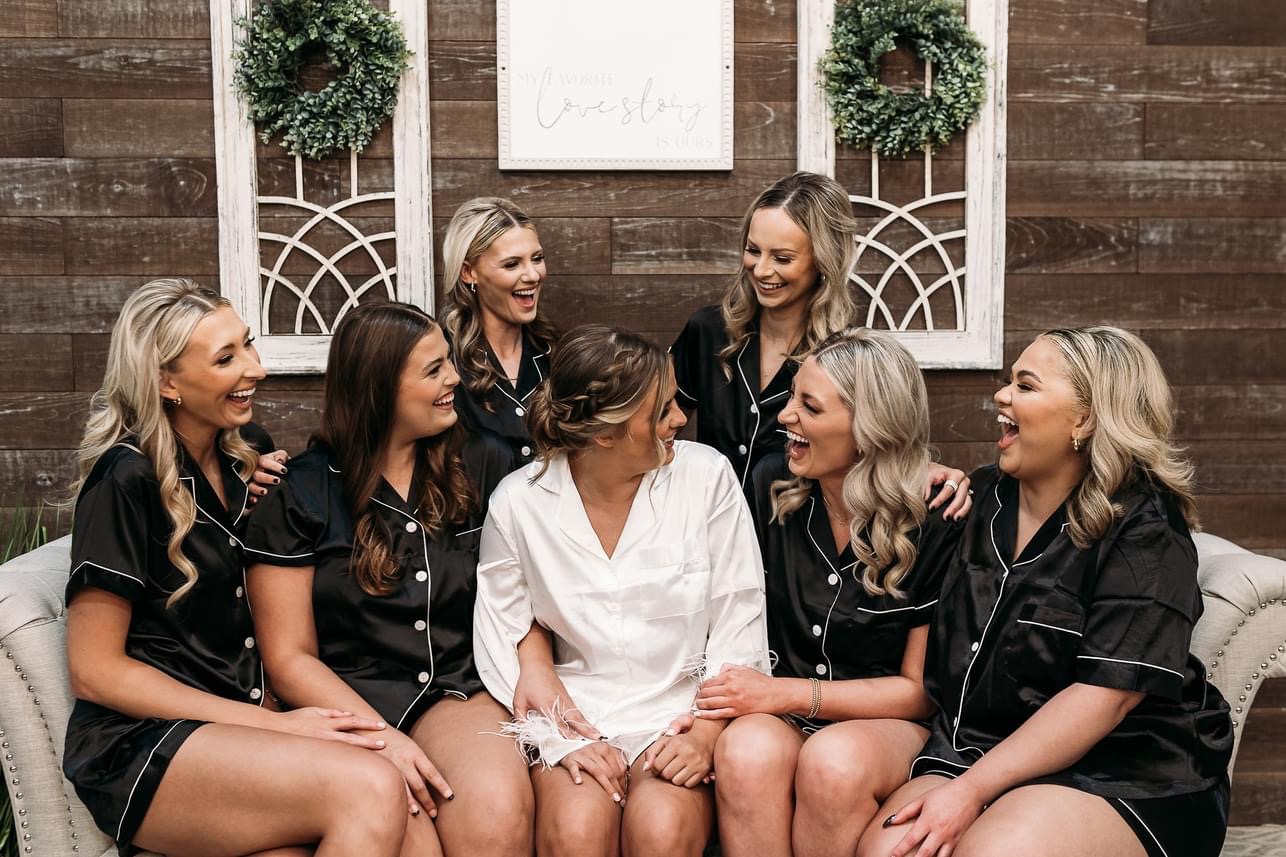 Bridesmaids laughing on couch at The Meadows Event Venue