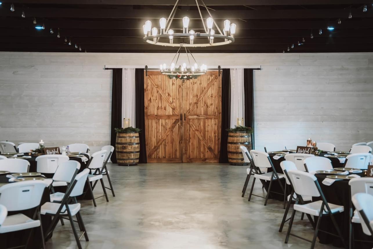 The Meadows Event Venue Image Gallery: Decorated interior and sliding barn door.